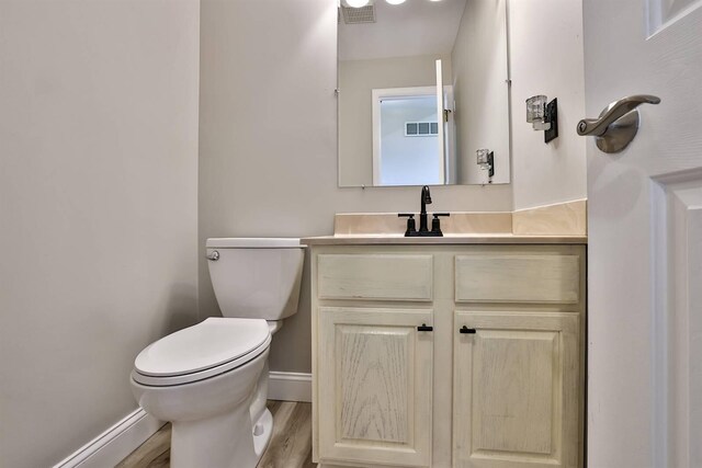 8949 E Main St, Alexandria, KY 41001 - bathroom with toilet, baseboards, vanity, and wood finished floors