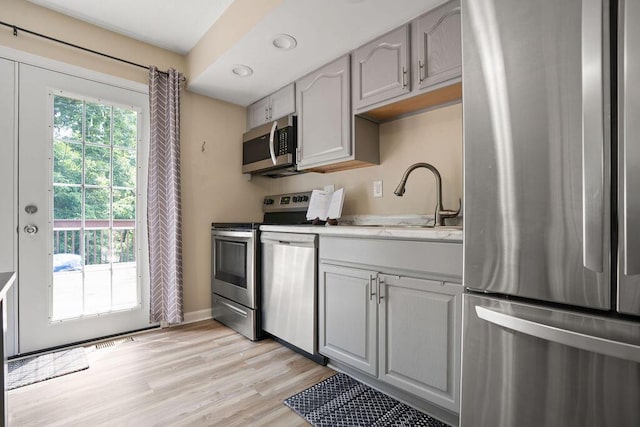 6161 Ridgewood Ct, Florence, KY 41042 - kitchen with appliances with stainless steel finishes, light wood-style floors, gray cabinets, and recessed lighting