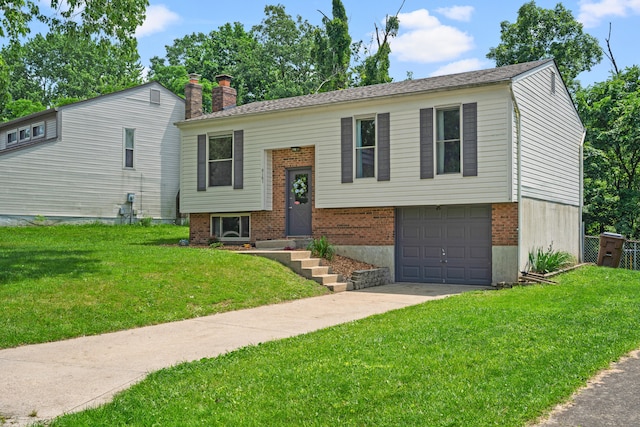 6161 Ridgewood Ct, Florence, KY 41042 - bi-level home featuring an attached garage, concrete driveway, a front lawn, a chimney, and brick siding