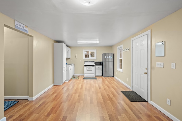 873 Buckeye Hills Rd, Falmouth, KY 41040 - kitchen with appliances with stainless steel finishes, light wood-style floors, white cabinetry, and baseboards