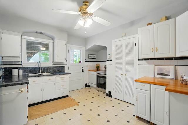 2 W Crittenden Ave, Fort Wright, KY 41011 - kitchen with stainless steel electric range, a sink, white cabinetry, a ceiling fan, and butcher block countertops