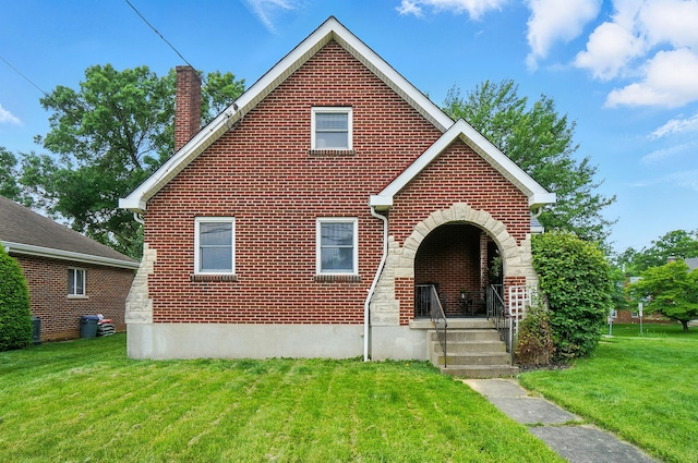 2 W Crittenden Ave, Fort Wright, KY 41011 - view of front of house featuring a chimney, a front lawn, and brick siding