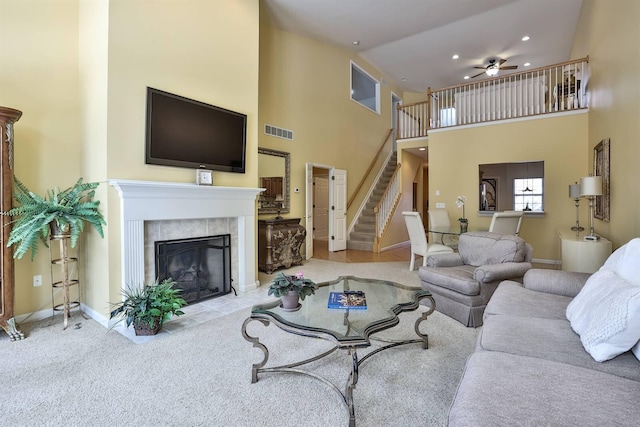 2754 Mansion Pl, Crestview Hills, KY 41017 - carpeted living room with a towering ceiling, stairs, ceiling fan, baseboards, and a tile fireplace
