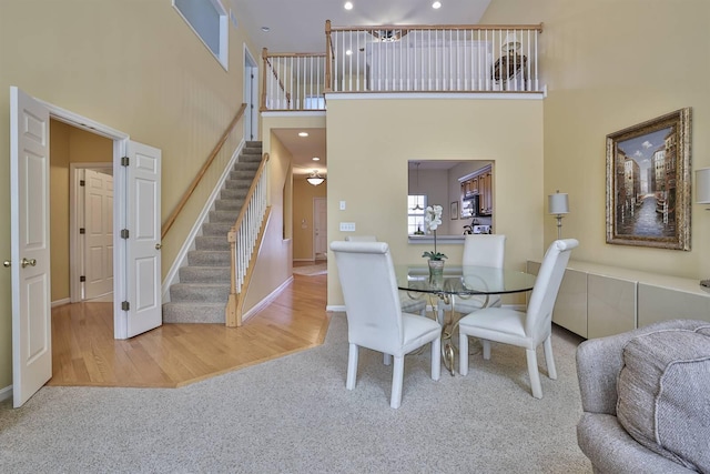 2754 Mansion Pl, Crestview Hills, KY 41017 - dining area featuring a high ceiling, stairway, carpet flooring, recessed lighting, and baseboards