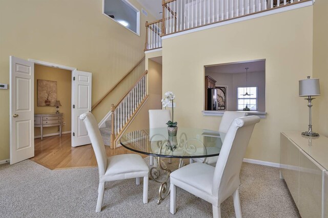 2754 Mansion Pl, Crestview Hills, KY 41017 - dining area with a high ceiling, carpet flooring, stairs, and baseboards