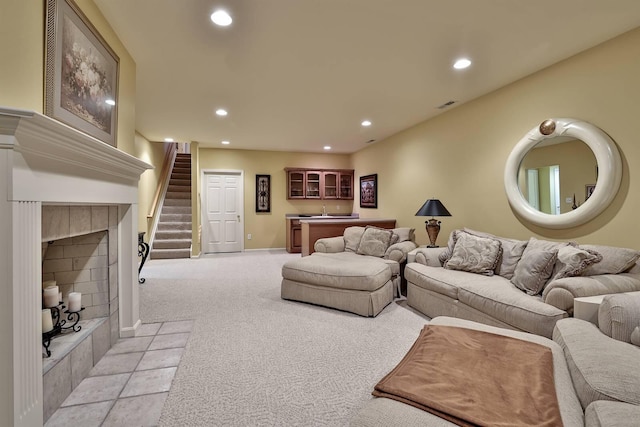 2754 Mansion Pl, Crestview Hills, KY 41017 - living area with recessed lighting, bar, stairs, light carpet, and a tiled fireplace