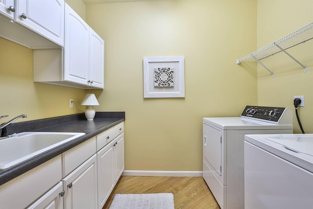 2754 Mansion Pl, Crestview Hills, KY 41017 - laundry area featuring independent washer and dryer, cabinet space, light wood-style floors, and baseboards