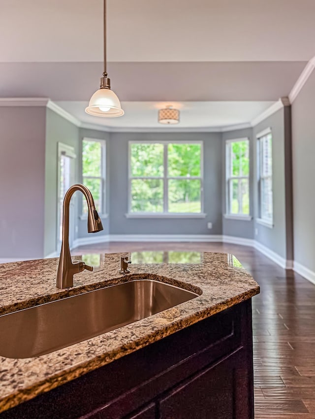 2563 Twin Hills Ct, Union, KY 41091 - kitchen featuring a sink, ornamental molding, light stone countertops, hanging light fixtures, and dark wood-style flooring