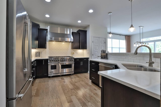 6520 Cannondale Dr, Burlington, KY 41005 - kitchen with appliances with stainless steel finishes, wall chimney range hood, a sink, decorative backsplash, and recessed lighting