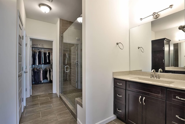 6520 Cannondale Dr, Burlington, KY 41005 - bathroom featuring vanity, a stall shower, a walk in closet, and baseboards