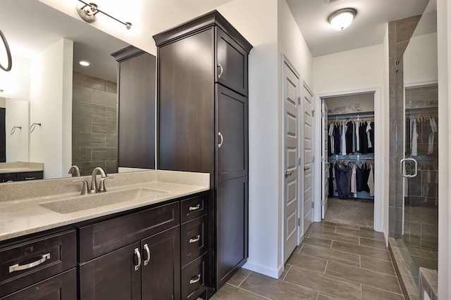 6520 Cannondale Dr, Burlington, KY 41005 - bathroom with vanity, a spacious closet, and tiled shower