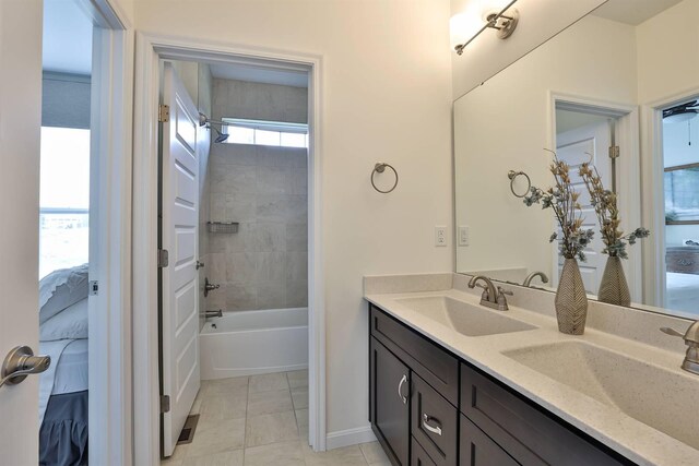 6520 Cannondale Dr, Burlington, KY 41005 - full bath with ensuite bathroom, double vanity, tile patterned floors, shower / tub combination, and baseboards