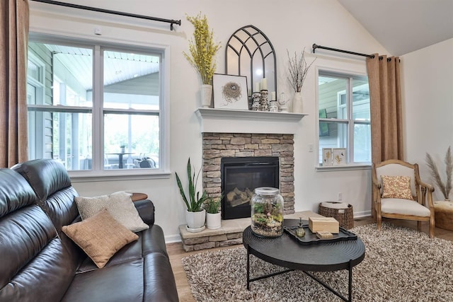 6520 Cannondale Dr, Burlington, KY 41005 - living area featuring wood finished floors, vaulted ceiling, a stone fireplace, and baseboards
