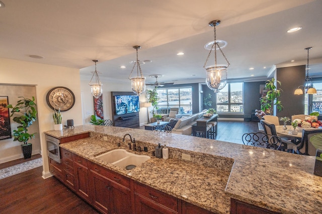 101 Harbor Greene Dr Unit W705, Bellevue, KY 41073 - kitchen featuring a sink, stainless steel microwave, baseboards, ornamental molding, and light stone countertops