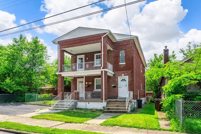 309 Hawthorne St, Covington, KY 41014 - townhome / multi-family property with brick siding, a porch, and a balcony