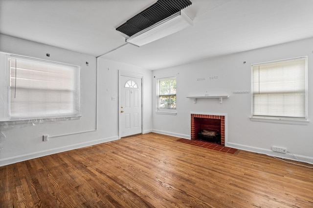 309 Hawthorne St, Covington, KY 41014 - unfurnished living room with wood finished floors, baseboards, and a fireplace
