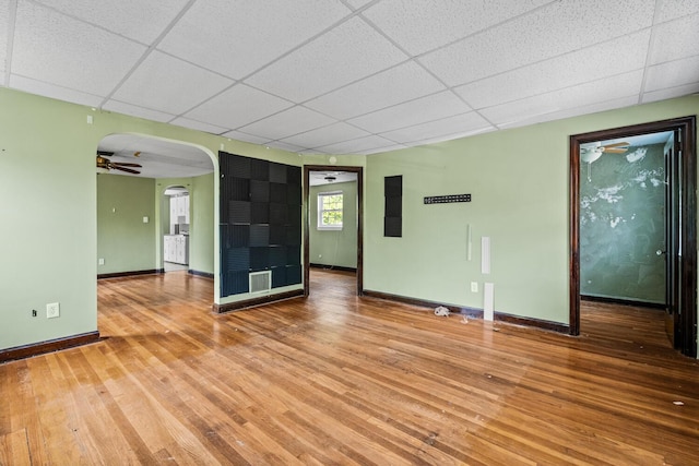 309 Hawthorne St, Covington, KY 41014 - unfurnished room featuring a paneled ceiling, light wood-style floors, arched walkways, baseboards, and a ceiling fan