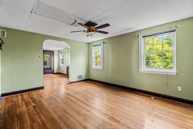 309 Hawthorne St, Covington, KY 41014 - spare room featuring arched walkways, wood finished floors, a ceiling fan, and baseboards
