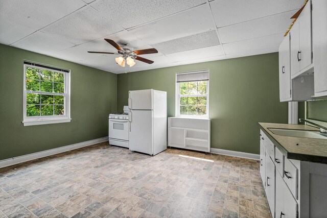 309 Hawthorne St, Covington, KY 41014 - kitchen with white appliances, a sink, baseboards, ceiling fan, and a paneled ceiling