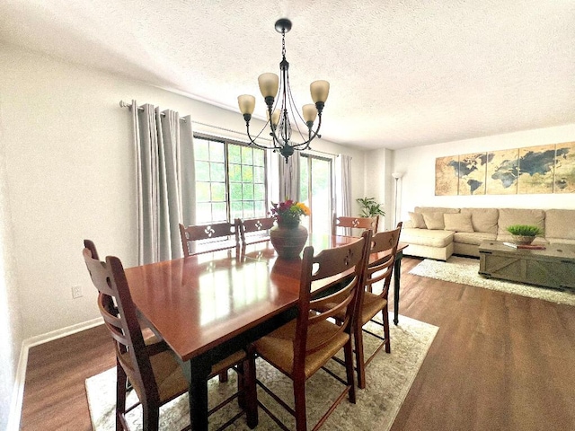 202 Shaker Heights Ln, Crestview Hills, KY 41017 - dining area featuring a chandelier, wood finished floors, a textured ceiling, and baseboards