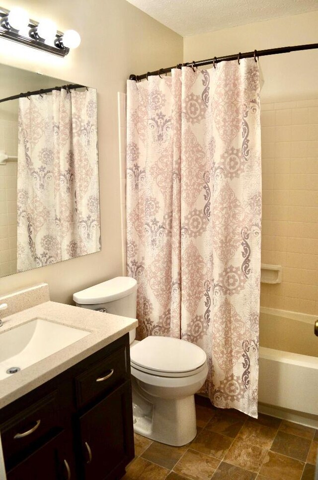 202 Shaker Heights Ln, Crestview Hills, KY 41017 - bathroom with vanity, toilet, shower / bath combo, a textured ceiling, and stone finish flooring