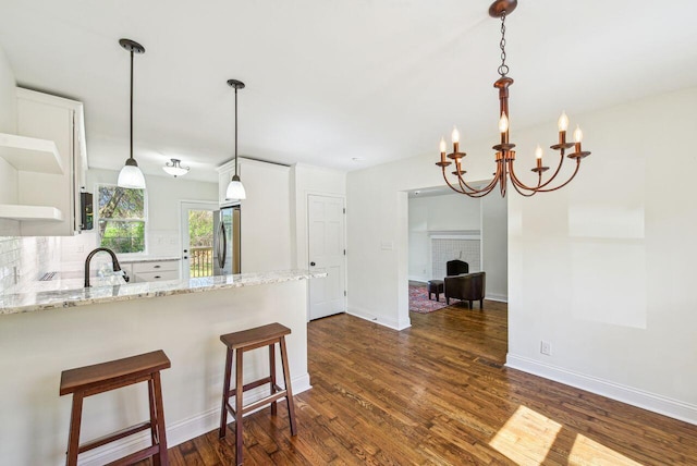 831 Linden Ave, Newport, KY 41071 - kitchen with freestanding refrigerator, decorative backsplash, dark wood-style flooring, open shelves, and light stone counters