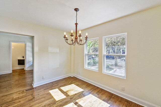 831 Linden Ave, Newport, KY 41071 - empty room with a chandelier, wood finished floors, and baseboards