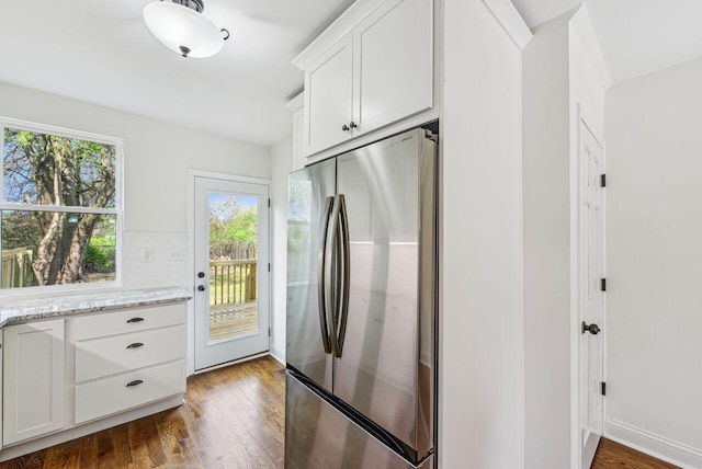 831 Linden Ave, Newport, KY 41071 - kitchen featuring freestanding refrigerator, dark wood-style flooring, white cabinetry, light stone countertops, and tasteful backsplash