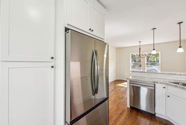 831 Linden Ave, Newport, KY 41071 - kitchen with stainless steel appliances, white cabinetry, a chandelier, dark wood-type flooring, and light stone counters