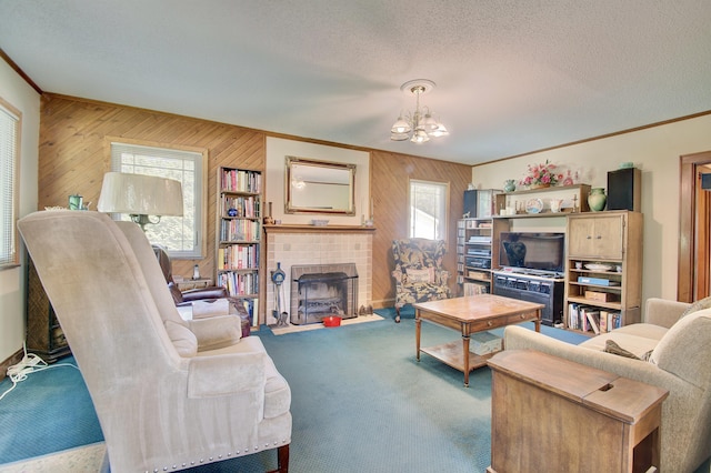 2641 Turkeyfoot Rd, Lakeside Park, KY 41017 - carpeted living room featuring wooden walls, ornamental molding, a chandelier, a brick fireplace, and a textured ceiling