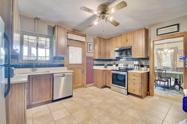 2641 Turkeyfoot Rd, Lakeside Park, KY 41017 - kitchen with appliances with stainless steel finishes, a sink, ceiling fan, decorative backsplash, and light countertops