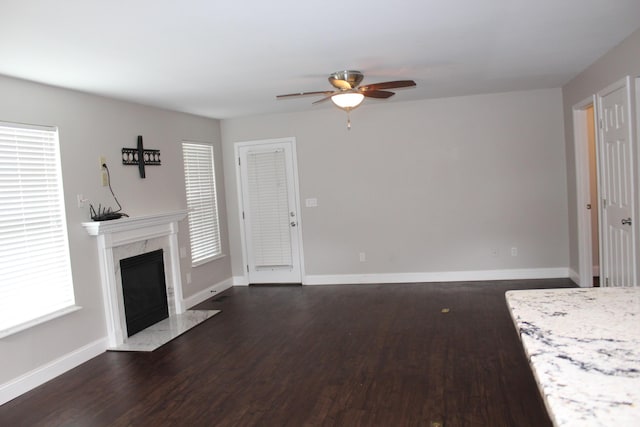 10083 Irish Way, Union, KY 41091 - unfurnished living room featuring a ceiling fan, dark wood-style flooring, a premium fireplace, and baseboards