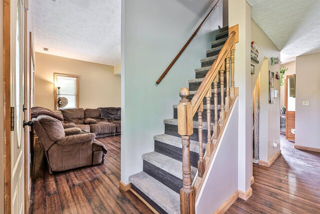 575 Stringtown Rd, Corinth, KY 41010 - stairway featuring a textured ceiling and wood-type flooring