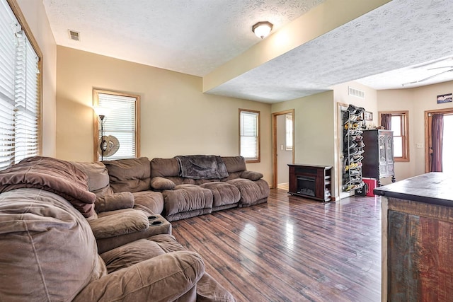 575 Stringtown Rd, Corinth, KY 41010 - living room featuring a textured ceiling, dark wood-style flooring, and a fireplace
