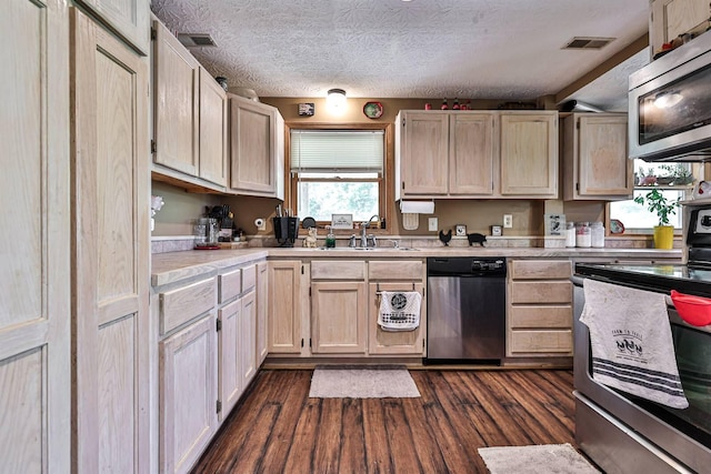 575 Stringtown Rd, Corinth, KY 41010 - kitchen with stainless steel appliances, light countertops, light brown cabinets, dark wood-type flooring, and a textured ceiling