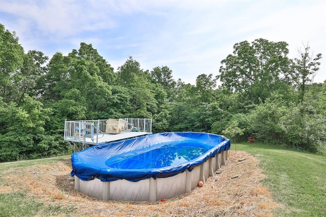 575 Stringtown Rd, Corinth, KY 41010 - view of swimming pool featuring a deck, a covered pool, and a wooded view