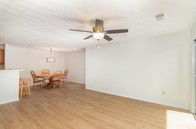 2308 Sawmill Ct Unit 207, Burlington, KY 41005 - dining space with light wood finished floors, baseboards, a ceiling fan, and a textured ceiling
