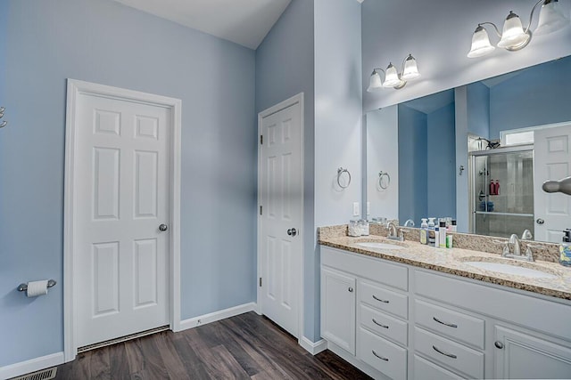 10658 Blooming Ct, Independence, KY 41051 - bathroom featuring a stall shower, double vanity, and wood finished floors