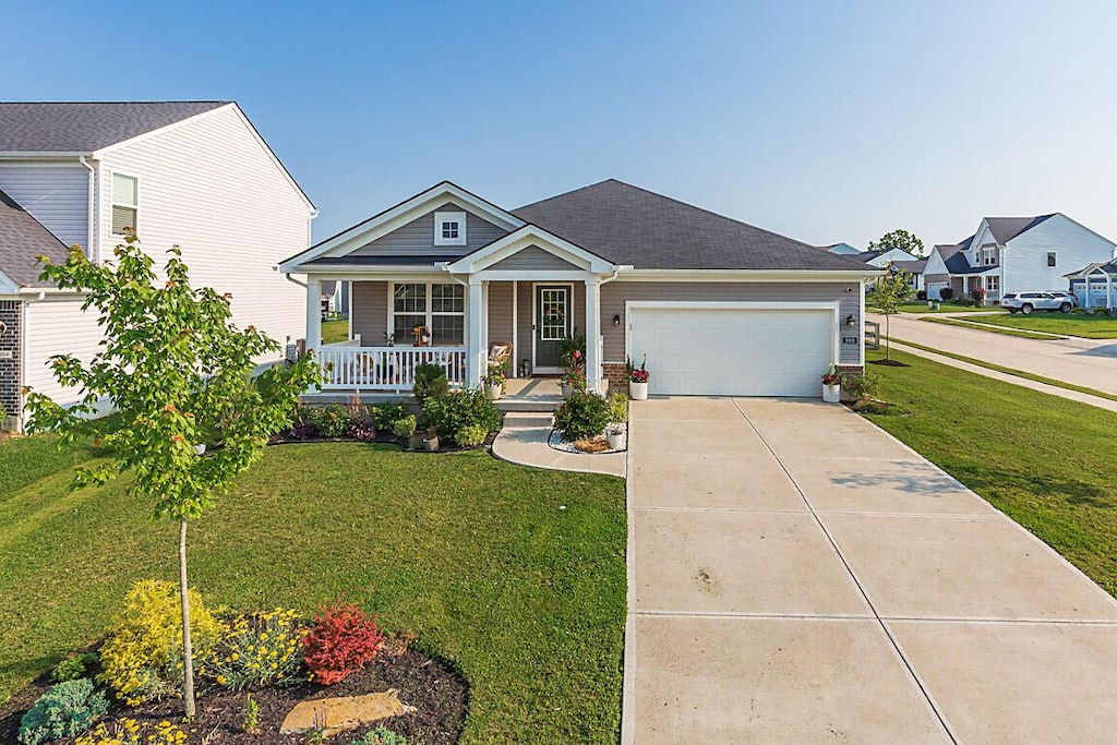 900 Riesling Ct, Walton, KY 41094 - view of front of house with covered porch, a garage, a front lawn, and driveway