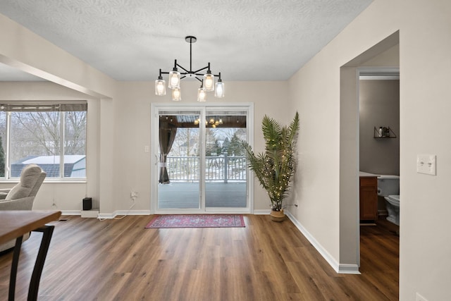 10335 Mackay Ct, Independence, KY 41051 - unfurnished dining area featuring wood finished floors, plenty of natural light, a chandelier, and a textured ceiling