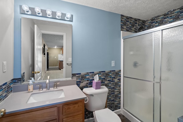 10335 Mackay Ct, Independence, KY 41051 - full bathroom with tile walls, vanity, a shower stall, toilet, and a textured ceiling