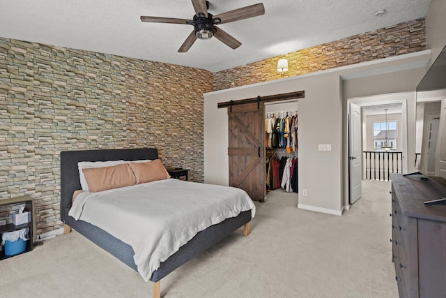 10335 Mackay Ct, Independence, KY 41051 - bedroom featuring a barn door, light carpet, a textured ceiling, a spacious closet, and a closet
