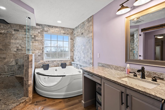 10335 Mackay Ct, Independence, KY 41051 - bathroom with vanity, a tub with jets, walk in shower, wood finished floors, and a textured ceiling