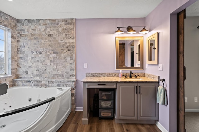 10335 Mackay Ct, Independence, KY 41051 - full bathroom with a whirlpool tub, wood finished floors, vanity, and baseboards