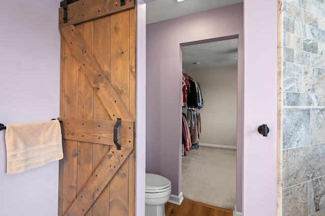 10335 Mackay Ct, Independence, KY 41051 - bathroom featuring toilet, baseboards, wood finished floors, and a closet
