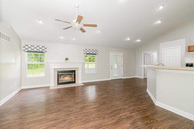 1285 Edinburgh Ln, Union, KY 41091 - unfurnished living room featuring vaulted ceiling, ceiling fan, plenty of natural light, dark wood-style flooring, and a tile fireplace