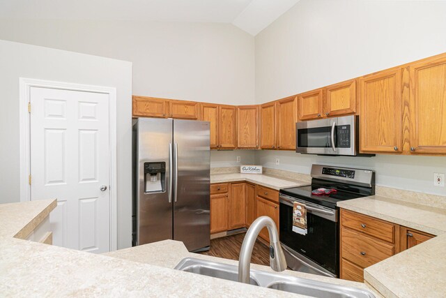 1285 Edinburgh Ln, Union, KY 41091 - kitchen featuring stainless steel appliances, light countertops, high vaulted ceiling, and dark wood-type flooring