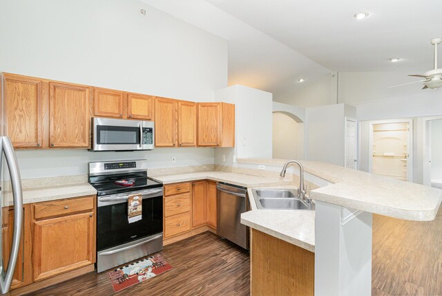1285 Edinburgh Ln, Union, KY 41091 - kitchen featuring stainless steel appliances, a peninsula, light countertops, dark wood finished floors, and high vaulted ceiling