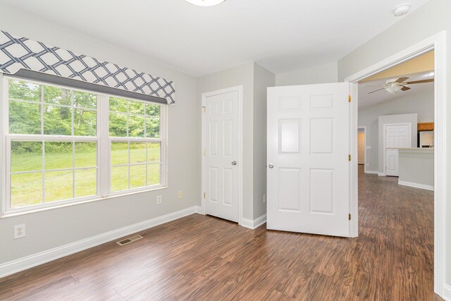 1285 Edinburgh Ln, Union, KY 41091 - unfurnished bedroom featuring dark wood-type flooring, multiple windows, freestanding refrigerator, and vaulted ceiling