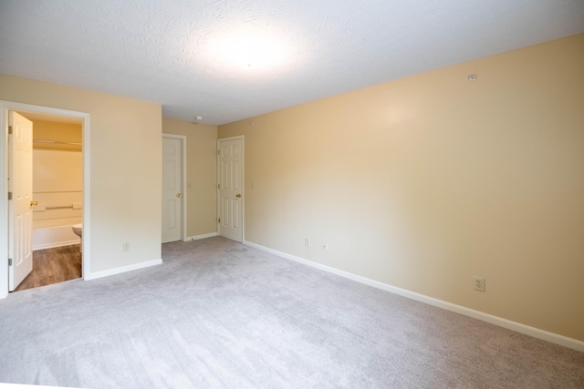 701 Napa Valley Ln Unit 9, Crestview Hills, KY 41017 - unfurnished bedroom with carpet flooring, ensuite bath, and a textured ceiling